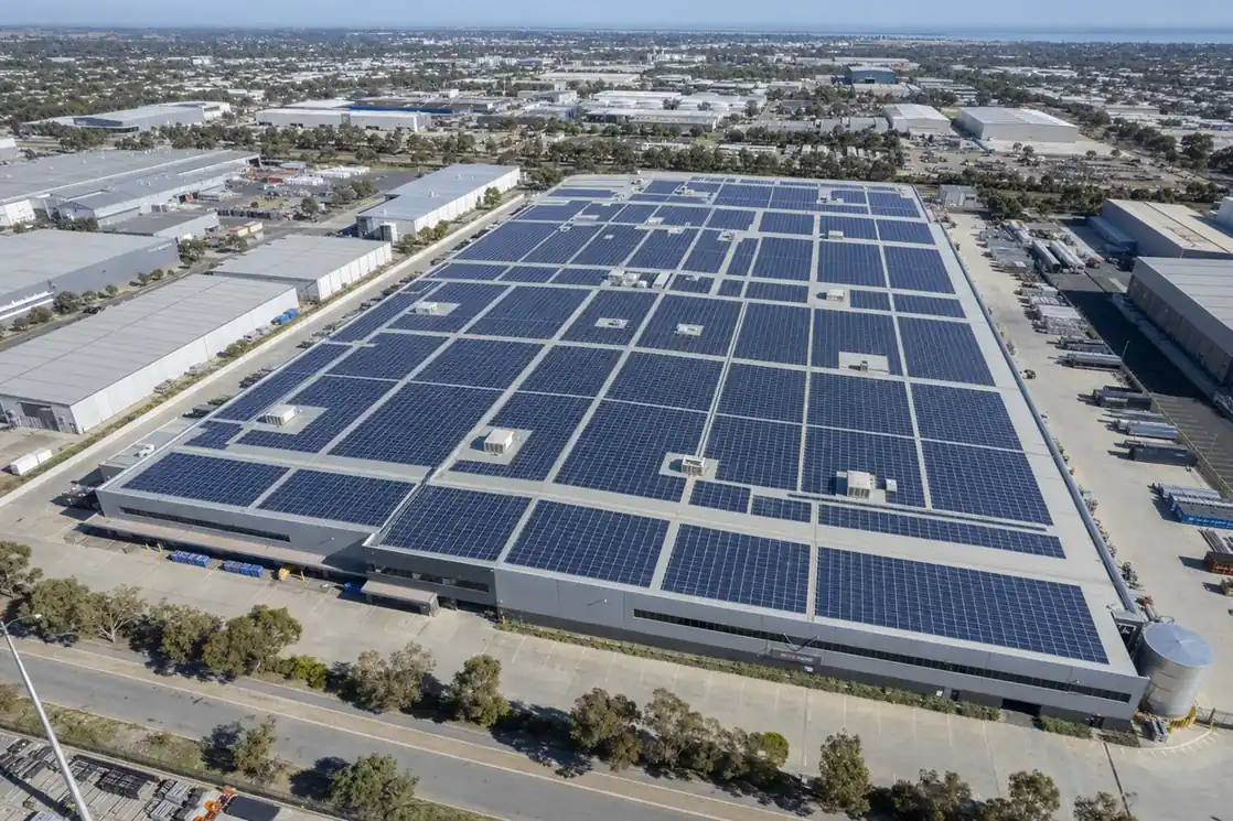 Aerial view of a large commercial rooftop solar array on an Adelaide industrial warehouse