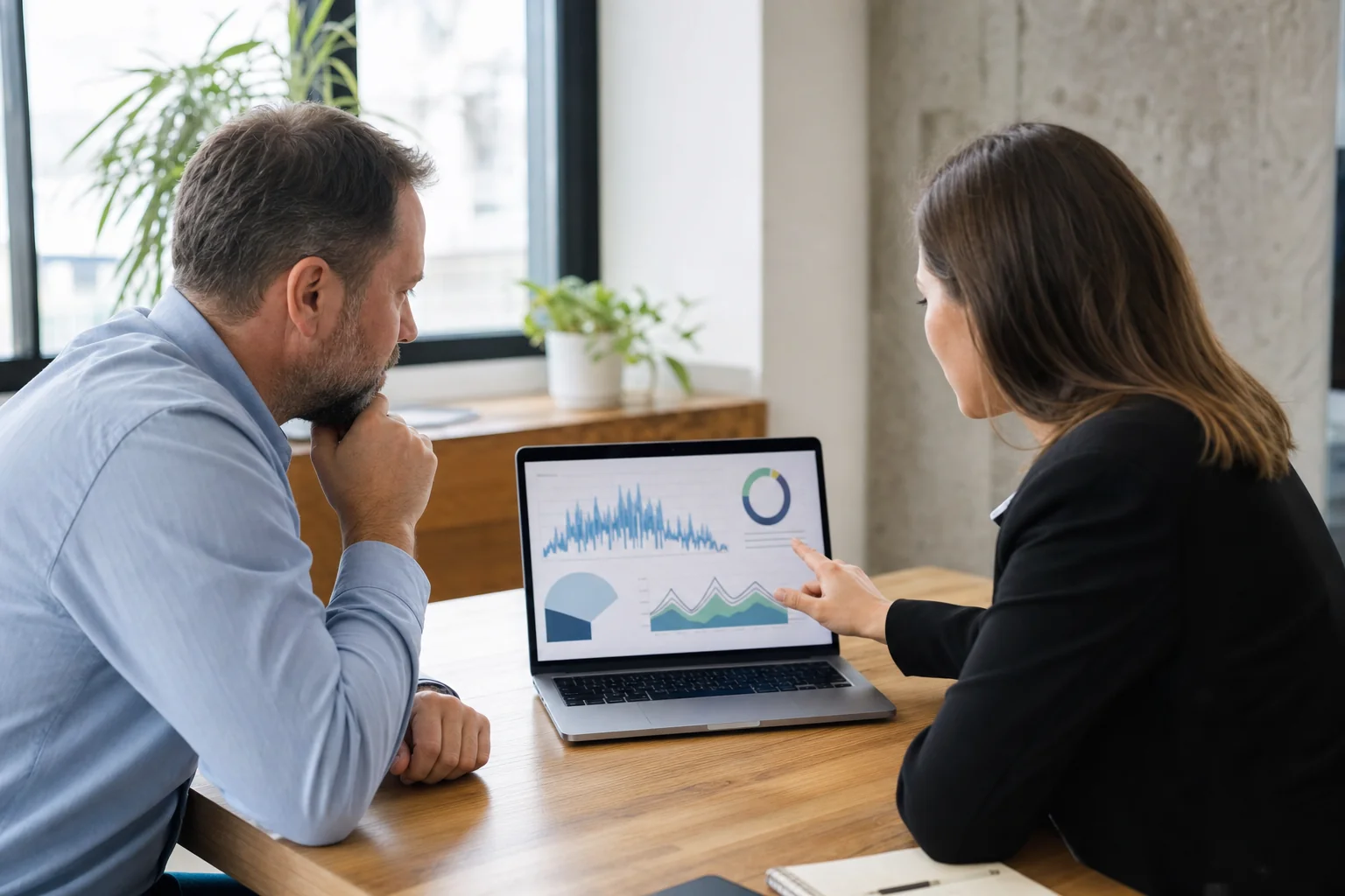 Business owner reviewing commercial solar performance data with an energy consultant