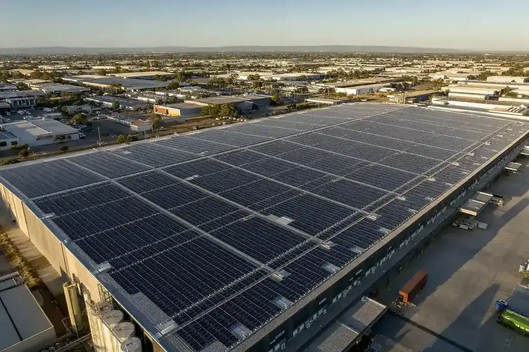 Aerial view of a large commercial rooftop solar array on an Adelaide industrial warehouse